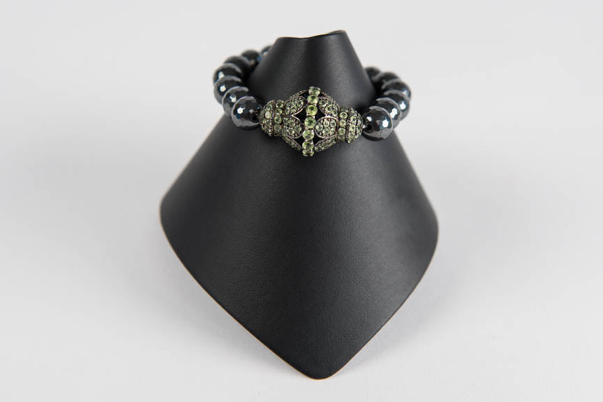 Faceted hematite with peridot bead
