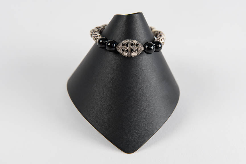 Carved bone and black onyx with rose cut diamond bead