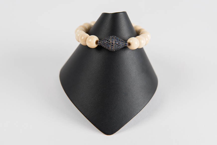 Bone with sapphire bead