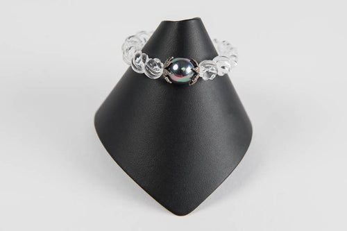 Carved rock crystal with mother of pearl and pave diamond bead caps