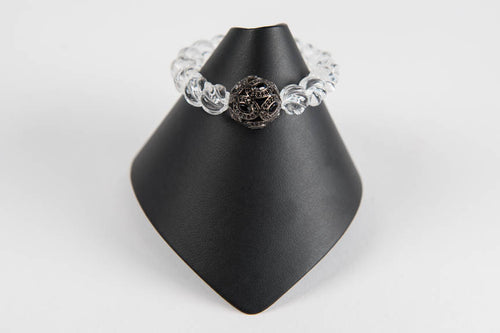 Carved rock crystal and black spinel bead