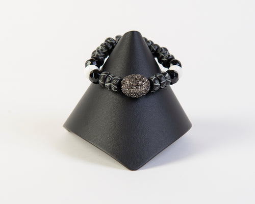 Hematite focal bead on carved bone and agate