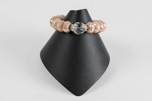 Faceted peach moonstone with carved rock crystal bead