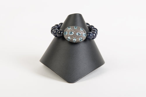 Blue topaz and white topaz focal bead on navy goldstone